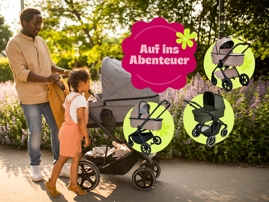 Auf ins Abenteuer! Vater mit Tochter schieben einen Kinderwagen durch einen Park!