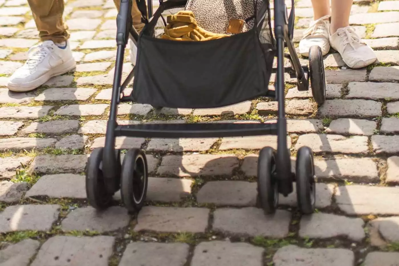 Eine frau drückt ihr baby in einem kinderwagen.